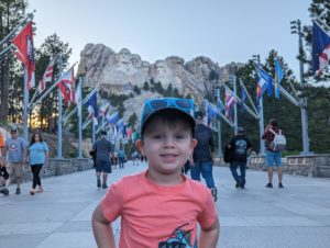 cute toddler posing in front of Mount Rushmore