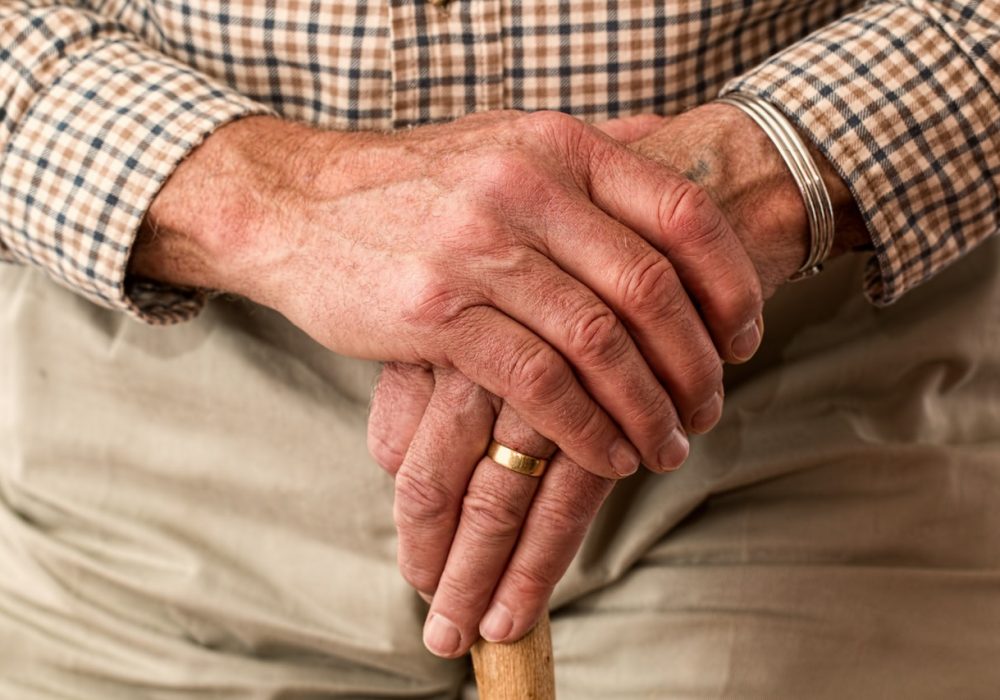 elderly male hands with cane